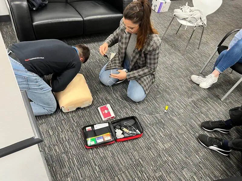 Applying bandage to arm during training